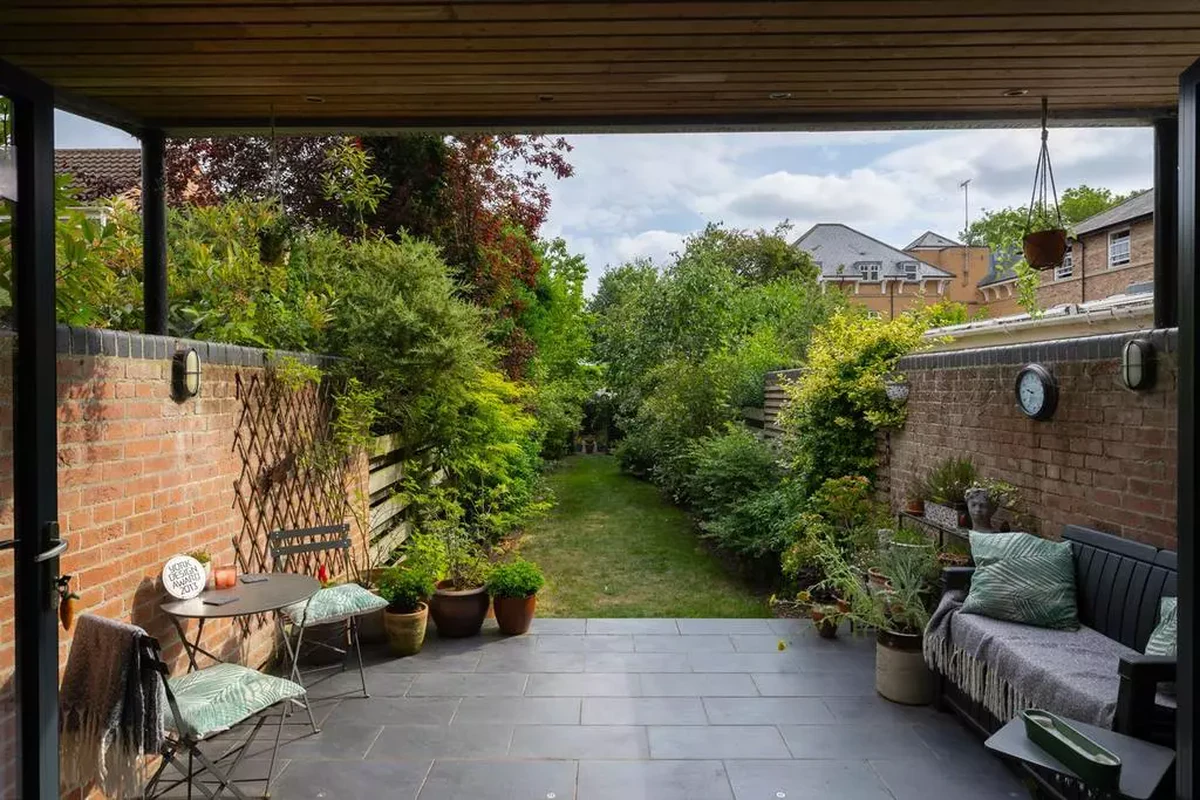 Covered patio of award-winning rear extension overlooking long garden, listed restoration York