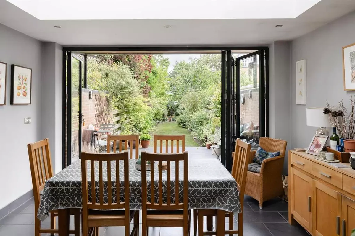 Bifold doors opening dining extension onto garden in Grade II listed Bootham home, York