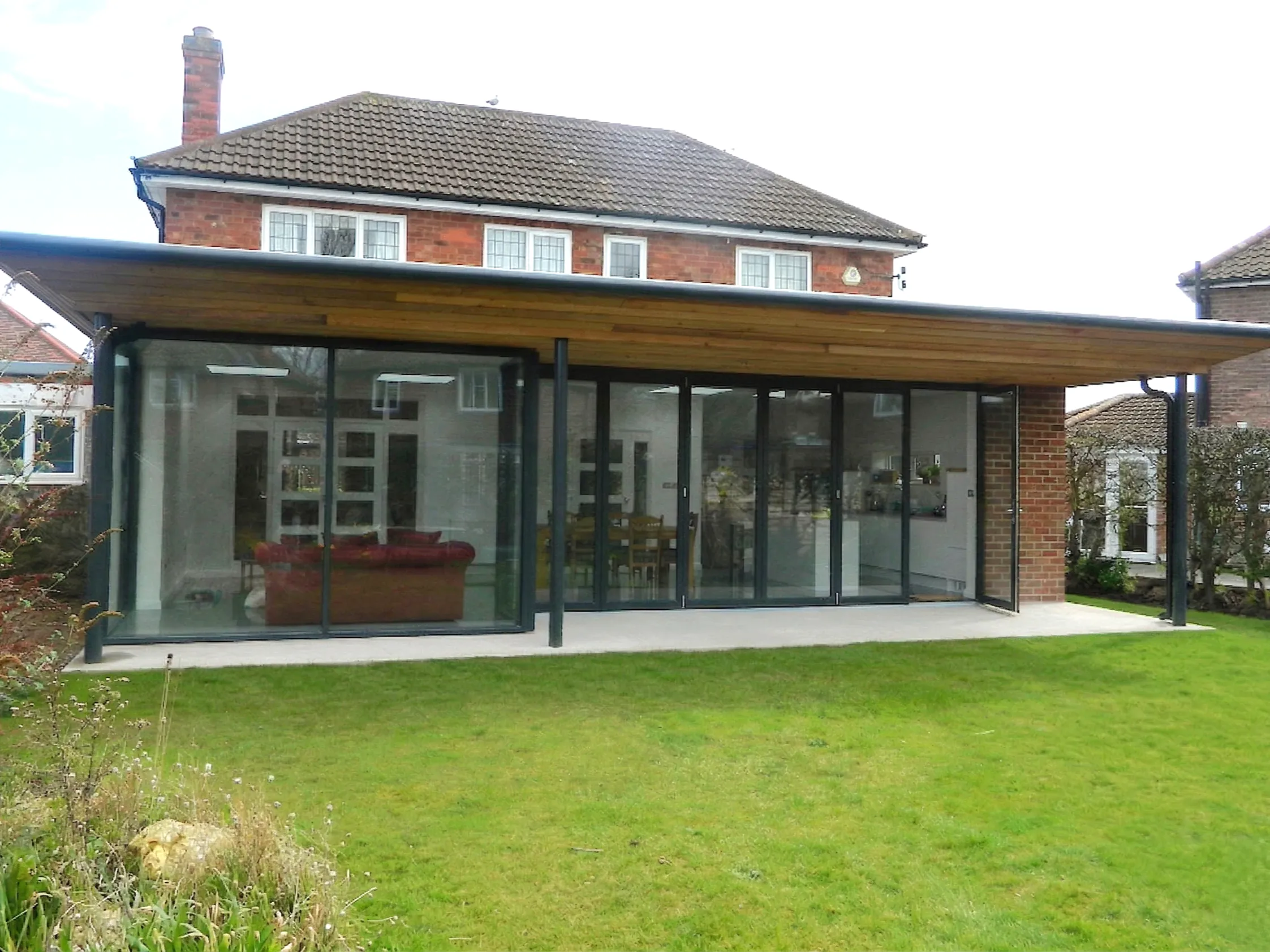View of a modern rear extension featuring extensive glazing and bi-folding doors, replacing a traditional conservatory in a suburban York home