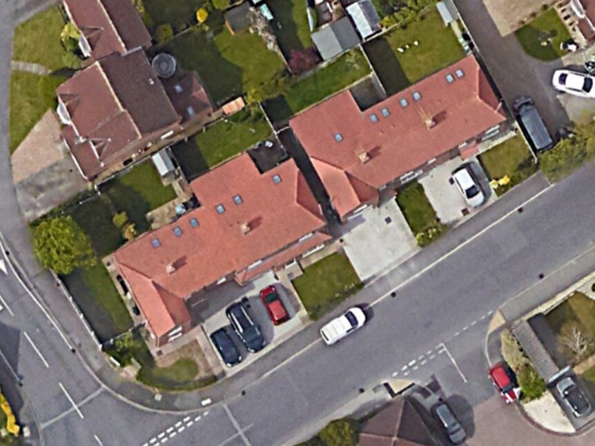 Aerial view of four completed semi-detached two-storey dwellinghouses at Manor Lane and Holyrood Drive, Rawcliffe, York, showing red-tiled roofs with dormer windows, private rear gardens, and off-street parking to the Manor Lane frontage