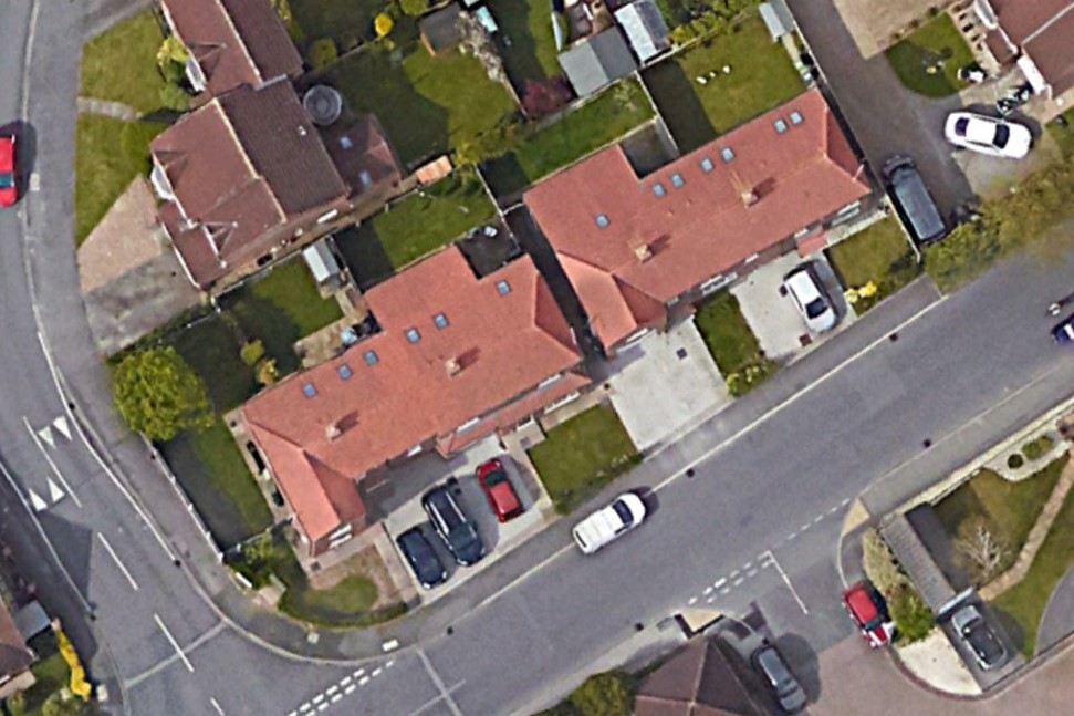 Aerial view of four completed semi-detached two-storey dwellinghouses at Manor Lane and Holyrood Drive, Rawcliffe, York, showing red-tiled roofs with dormer windows, private rear gardens, and off-street parking to the Manor Lane frontage