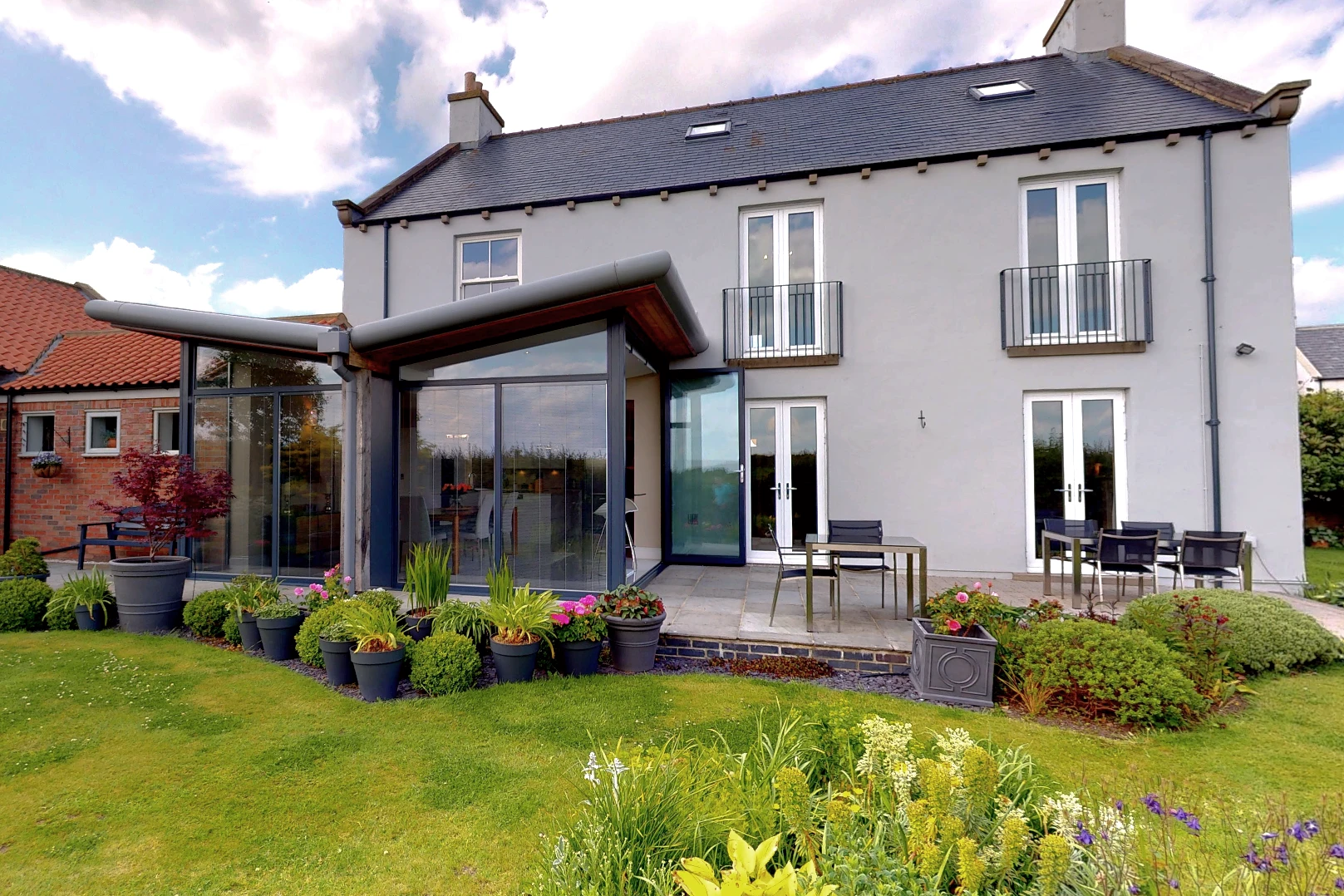 Contemporary Single Storey Extension Butterfly Roof Rounded Fascia and Timber Soffit