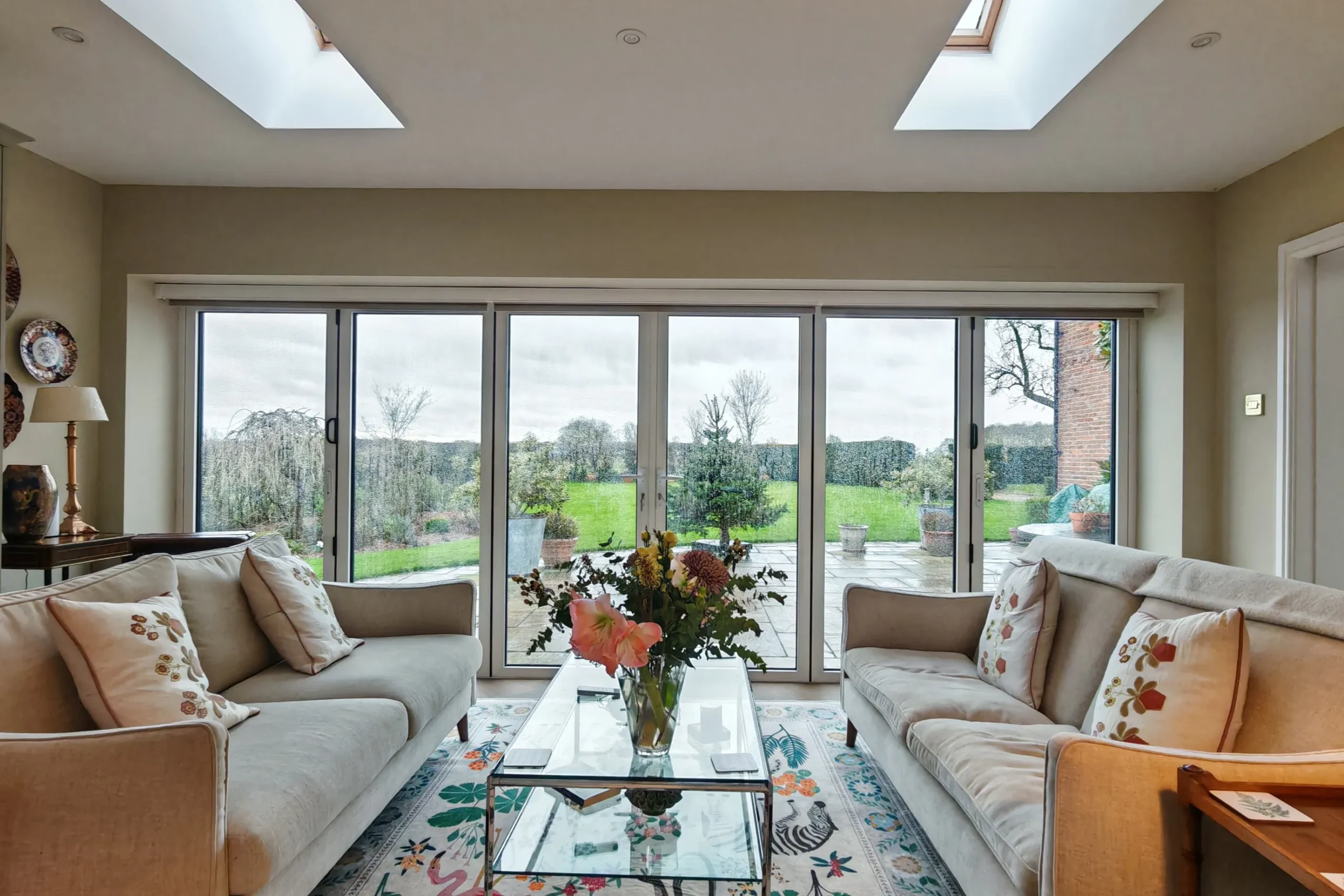 Interior of converted garage showing natural light with garden views through wide bifold doors, in Nether Poppleton, York, North Yorkshire