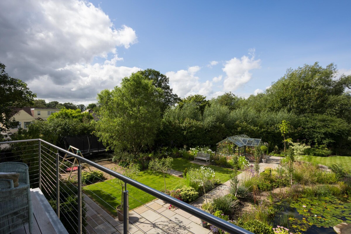 View from first floor balcony of double storey extension over landscaped garden and natural pool, Nether Poppleton conservation area York