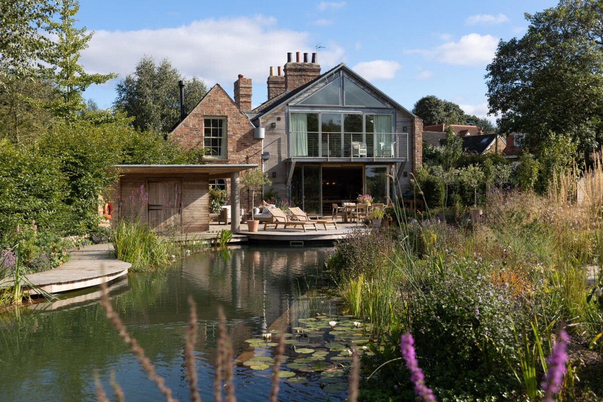 Rear elevation of double storey extension in conservation area, Nether Poppleton York, with natural swimming pool, cedar cladding and full-height glazed gable