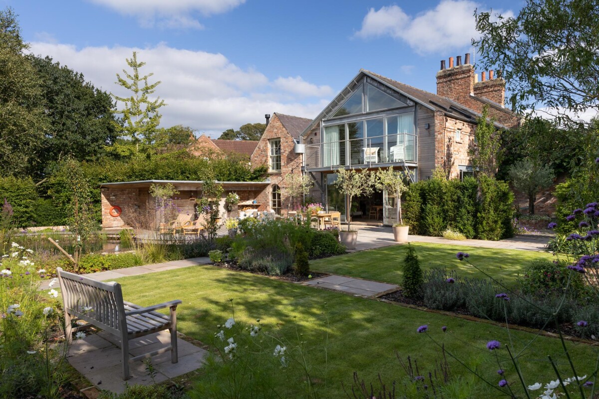 Landscaped rear garden with herbaceous borders and double storey glazed extension, Nether Poppleton conservation area York