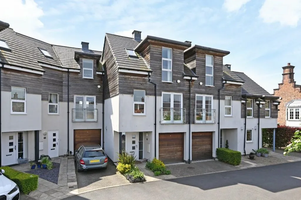 Contemporary extension listed building detail showing the silvered cedar cladding of the new townhouses adjacent to the restored 1890s Victorian brickwork.