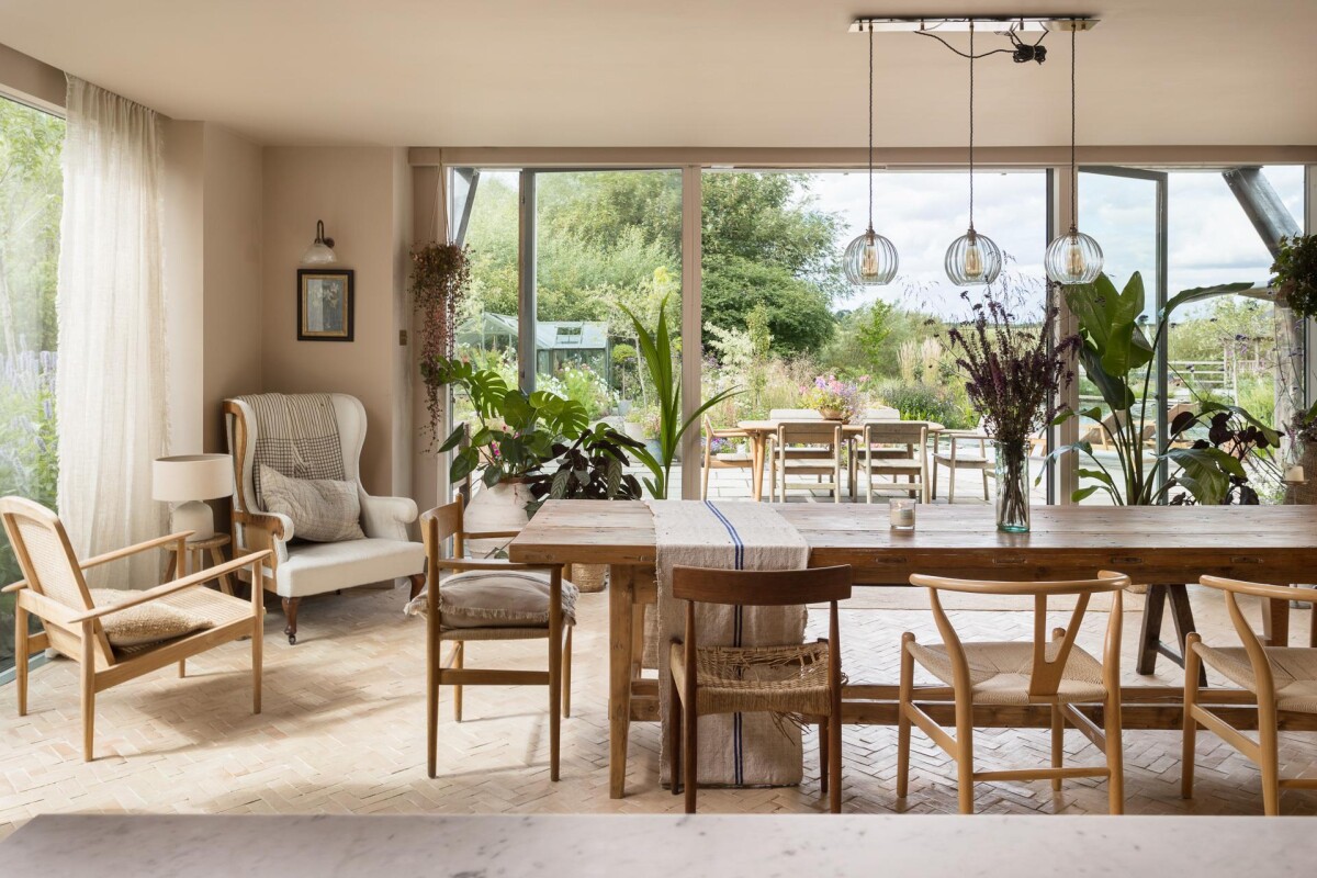 Open plan dining room inside period property extension in York, with full-width sliding glazed doors opening to the garden and herringbone brick floor