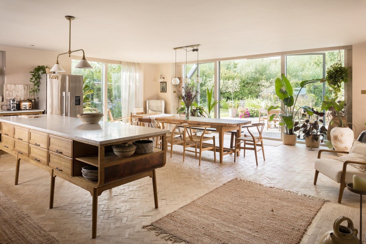 Open plan kitchen and dining room in double storey extension, Nether Poppleton York, with marble island, herringbone brick floor and full-width glazing to rear garden