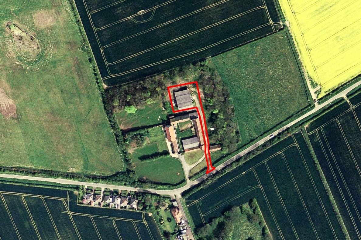 Aerial satellite view of Moor Farm, Hunmanby Gap, showing the Class Q prior approval application site outlined in red. The northern precast concrete agricultural barn subject to the Class Q conversion is visible within the red boundary, set within open countryside approximately 2km east of Hunmanby and 3km south of Filey, North Yorkshire.