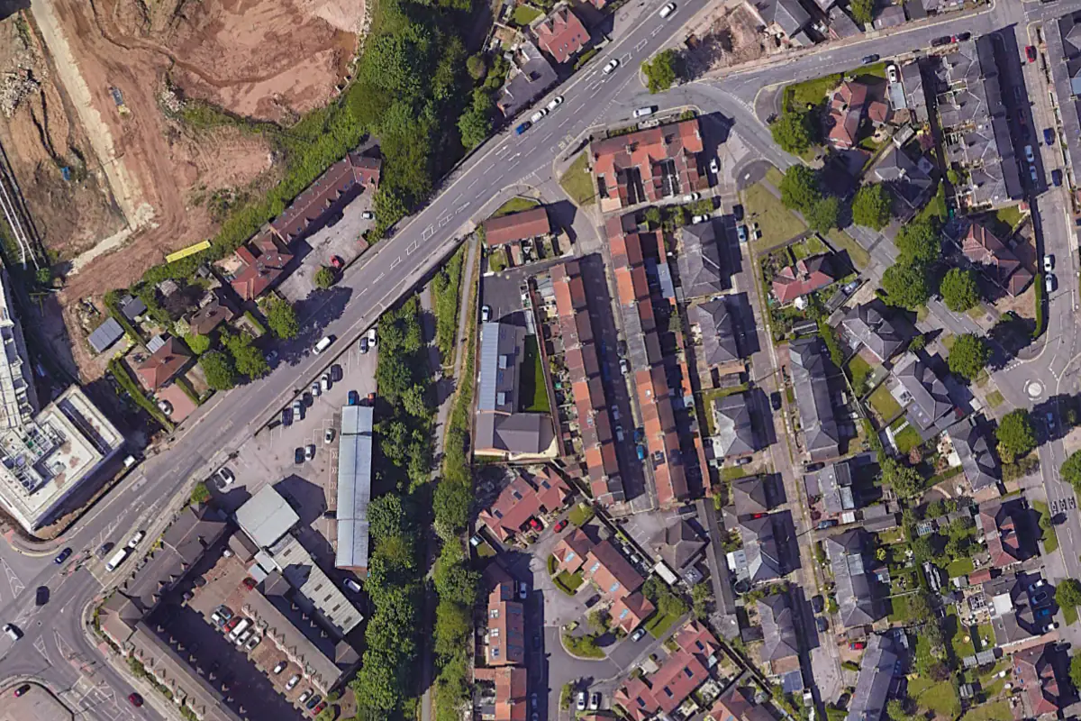 Aerial satellite photograph of the completed Hawthorn Street Apartments in Layerthorpe, York, showing the new L-shaped 10-apartment residential building by Fining Associates Architects replacing the former Glen Garage site, with the adjacent Foss Islands cycleway and surrounding Victorian terraced streetscape visible.